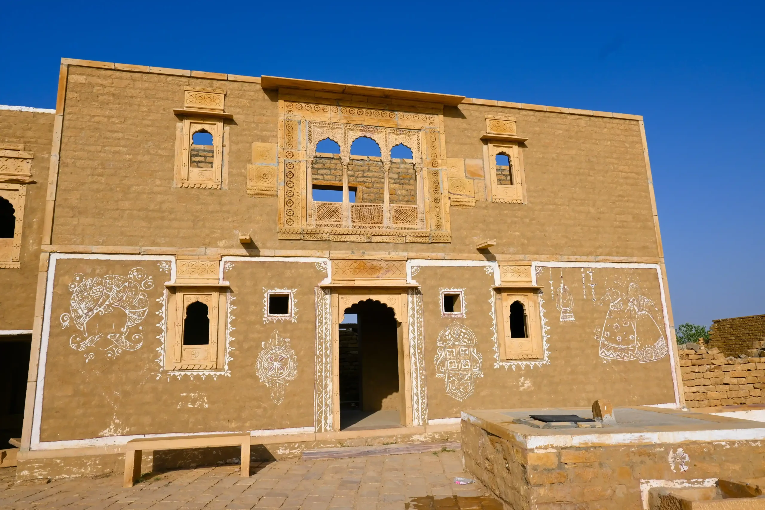 Decorated mud house ruins with carved jharokha in Kuldhara haunted village near Jaisalmer, Rajasthan