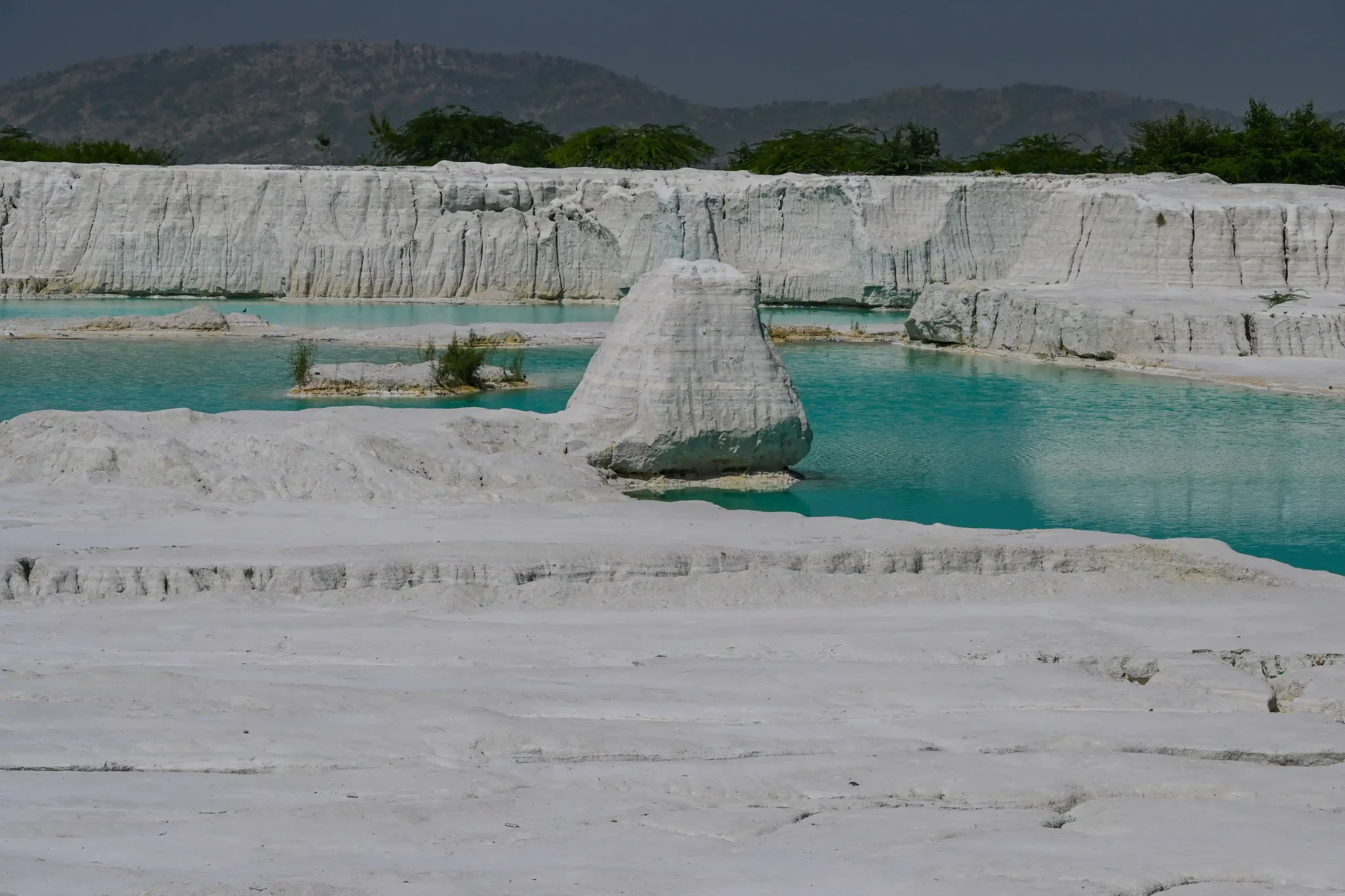 Turquoise pools amid white marble waste formations at Kishangarh dump yard, Rajasthan