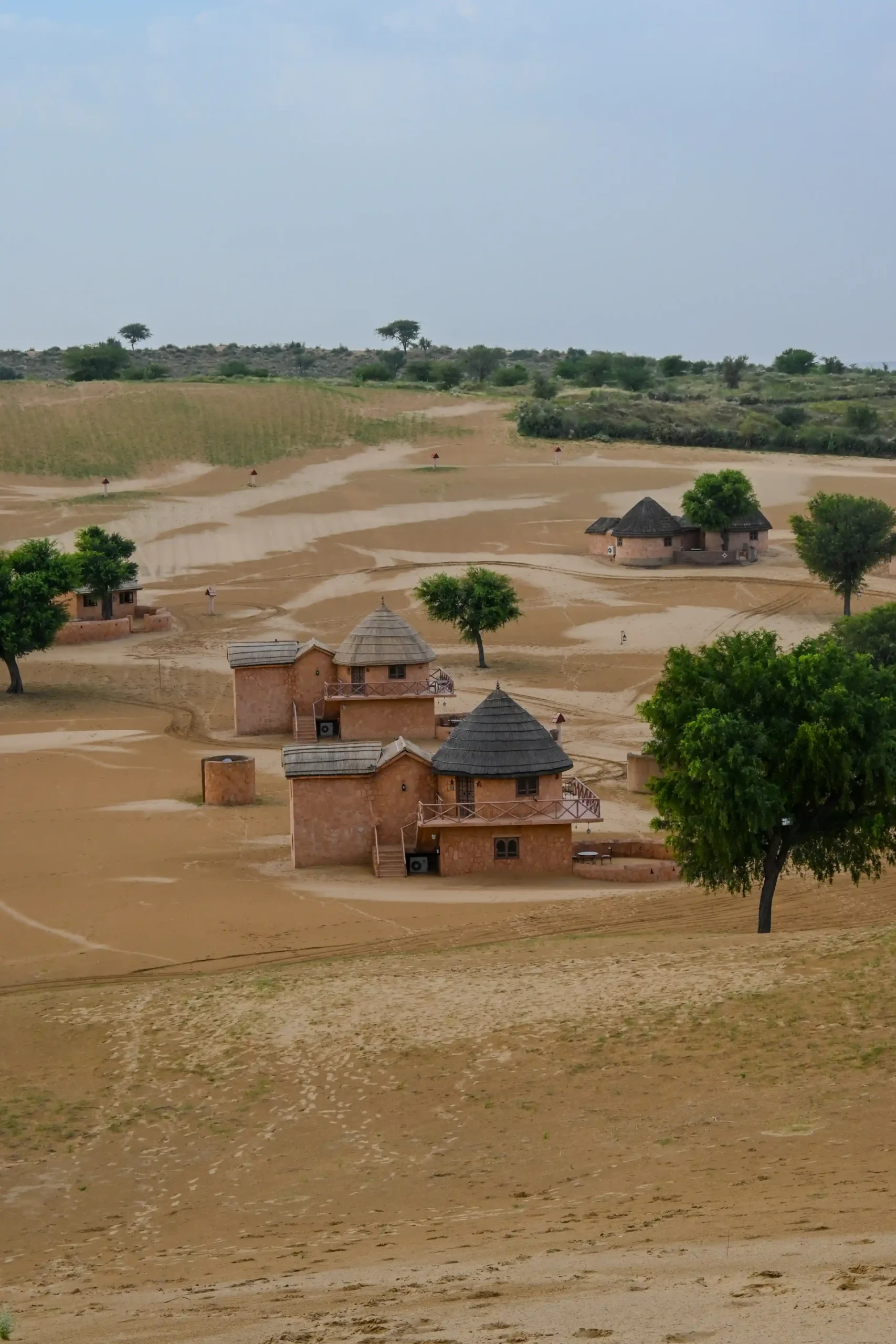 Close-up of traditional-style mud huts at Khimsar Sand Dunes Resort, nestled in Rajasthan’s golden Thar Desert with a blend of culture and calm.