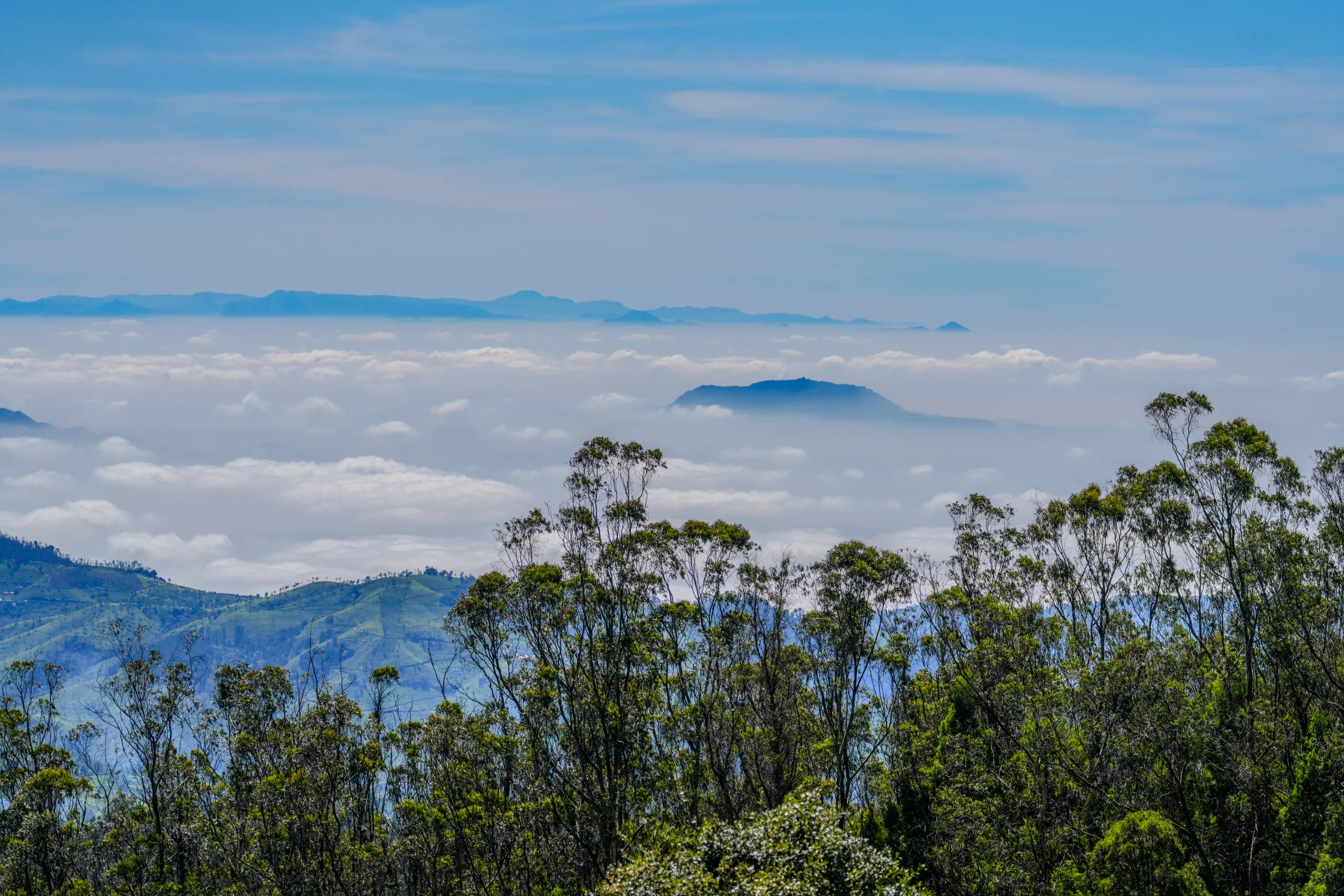 Floating clouds above distant hills seen from a high viewpoint in Ooty