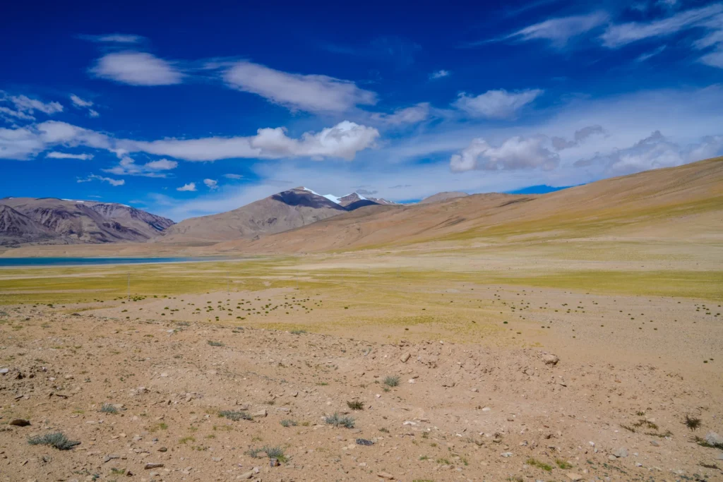 High-altitude desert plateau with a lake and snowy peaks in Leh Ladakh